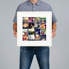 A man holds a white framed custom photo grid collage print against a solid gray background. The print is 30x30cm and the frame is 44x44cm. 