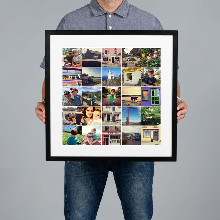A man holds up a large black-framed custom photo grid collage print with a white mat. The collage contains multiple small travel and family photographs. The print is 40x40cm and the frame is 54x54cm. 