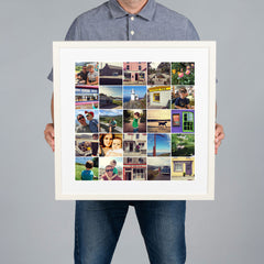 A man holds up a large White framed custom photo grid collage print with a white mat. The collage contains multiple small travel and family photographs. The print is 40x40cm and the frame is 54x54cm. 